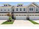 Attractive townhouse featuring a two-car garage, dormer windows, and green landscaping at 1237 Langham St, Avon, IN 46123