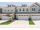 Stylish townhouse with a two-car garage, dormer windows, and manicured landscaping at 1237 Langham St, Avon, IN 46123