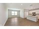 Open concept living room and kitchen area with a view to the modern kitchen island at 1237 Langham St, Avon, IN 46123