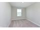 A simple bedroom has light gray walls, carpet, and one window at 1280 Newton St, Avon, IN 46123