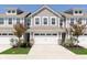 Charming townhome with two-car garage, stylish siding, and meticulously landscaped front yard at 1280 Newton St, Avon, IN 46123