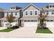 Attractive townhome showcasing a driveway leading to a spacious two-car garage and manicured lawn at 1280 Newton St, Avon, IN 46123