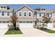 Inviting townhome with modern facade, showcasing a two-car garage and well-maintained landscaping at 1280 Newton St, Avon, IN 46123