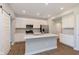 Bright kitchen with a large island, modern appliances, and sliding barn door at 1280 Newton St, Avon, IN 46123