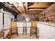 Basement space with exposed brick and wooden ceiling, featuring a unique seating area at 1310 Olive St, Indianapolis, IN 46203