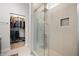 Modern bathroom with a glass shower, tiled walls and floors, and a view into the closet at 1310 Olive St, Indianapolis, IN 46203