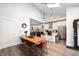 Dining area featuring hardwood floors, a modern light fixture, and open kitchen access at 1310 Olive St, Indianapolis, IN 46203