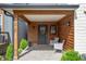 Inviting covered front porch with wood ceiling and columns, and stylish seating area at 1310 Olive St, Indianapolis, IN 46203