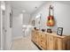 Hallway featuring a wooden cabinet and guitar on the wall, leading to stairs and other rooms at 1310 Olive St, Indianapolis, IN 46203