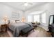 Bright main bedroom with a king bed, bench, and lots of natural light from large windows at 1310 Olive St, Indianapolis, IN 46203
