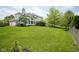 Lush backyard with green grass, mature trees, and a well-maintained lawn at 13244 Snow Owl Dr, Carmel, IN 46033