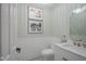 Elegant powder room with patterned wallpaper, white tile, marble countertop, and chic mirror at 13244 Snow Owl Dr, Carmel, IN 46033