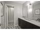 This bathroom features double sinks, marble countertops, and patterned tile floors at 13244 Snow Owl Dr, Carmel, IN 46033