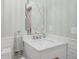 Stylish powder room featuring decorative mirror, white vanity with marble top, and modern fixtures at 13244 Snow Owl Dr, Carmel, IN 46033