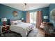 This stylish bedroom features a queen bed, blue walls, and orange chevron curtains at 13244 Snow Owl Dr, Carmel, IN 46033