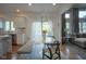 Bright dining room featuring a bright table with chairs and bench with a view of the kitchen and living room at 13244 Snow Owl Dr, Carmel, IN 46033