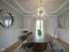 Bright dining room featuring a modern chandelier, large wood table and stylish decor at 13244 Snow Owl Dr, Carmel, IN 46033