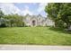 Beautiful two-story brick home with a well-manicured lawn and mature trees at 13244 Snow Owl Dr, Carmel, IN 46033
