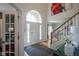 Inviting foyer with a staircase and a view into the living room through the archway at 13244 Snow Owl Dr, Carmel, IN 46033