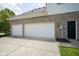 Spacious three-car garage with white doors and a paved driveway at 13244 Snow Owl Dr, Carmel, IN 46033