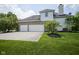 Spacious three-car garage with a large driveway and well-maintained landscaping at 13244 Snow Owl Dr, Carmel, IN 46033