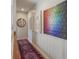 Well-lit hallway adorned with colorful artwork and a stylish runner rug at 13244 Snow Owl Dr, Carmel, IN 46033