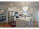 Bright and open kitchen featuring an island with bar seating, stainless steel appliances and modern lighting at 13244 Snow Owl Dr, Carmel, IN 46033