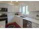 Close-up of a bright kitchen showcasing stainless steel appliances, hexagonal backsplash, and modern countertops at 13244 Snow Owl Dr, Carmel, IN 46033