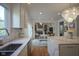 Bright kitchen with stainless steel appliances flowing into a living room with a fireplace and white table with seating at 13244 Snow Owl Dr, Carmel, IN 46033