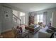 Bright living room featuring stylish decor, comfortable seating, and open view to the foyer at 13244 Snow Owl Dr, Carmel, IN 46033