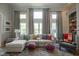 Bright living room with large windows, grey drapes, comfortable seating, and stylish decor at 13244 Snow Owl Dr, Carmel, IN 46033