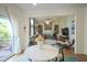Open concept kitchen and living room featuring a fireplace, comfortable seating, and a bright table with chairs at 13244 Snow Owl Dr, Carmel, IN 46033