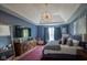 Luxurious main bedroom with blue walls, stylish lighting, and comfortable furniture at 13244 Snow Owl Dr, Carmel, IN 46033
