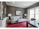 Home office with a sofa, area rug, and statement wallpaper, creating a cozy workspace at 13244 Snow Owl Dr, Carmel, IN 46033