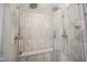 Elegant walk-in shower with designer tile, rainfall showerhead, and built-in bench seating at 13244 Snow Owl Dr, Carmel, IN 46033