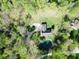 An aerial view of a home with a pond, surrounded by lush trees, and a circular driveway at 1340 Apache Trl, Martinsville, IN 46151