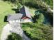 Aerial view of the home and property on a sunny day with a large pond in the backyard at 1340 Apache Trl, Martinsville, IN 46151