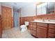 Bathroom with ceramic tile floors, wood paneled walls, and modern fixtures at 1340 Apache Trl, Martinsville, IN 46151
