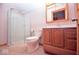 Bathroom with tile floor, corner shower, toilet, and wood vanity with mirror at 1340 Apache Trl, Martinsville, IN 46151