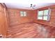 Warm bedroom with hardwood floors, wood paneling and natural light, creating a relaxing atmosphere at 1340 Apache Trl, Martinsville, IN 46151