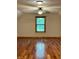 Well lit bedroom with beautiful hardwood floors and a large window at 1340 Apache Trl, Martinsville, IN 46151