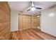 Bedroom highlighting wood paneled walls, wood floors, and a double-door closet at 1340 Apache Trl, Martinsville, IN 46151