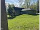 Back exterior of the home and yard on a sunny day at 1340 Apache Trl, Martinsville, IN 46151
