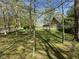 Exterior view of home and 3 car garage behind several trees on a sunny day at 1340 Apache Trl, Martinsville, IN 46151
