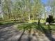 Street numbers posted by a circular driveway leading up to a house surrounded by lush trees at 1340 Apache Trl, Martinsville, IN 46151