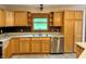 Cozy kitchen featuring wood cabinets, stainless steel appliances, and a window with a view at 1340 Apache Trl, Martinsville, IN 46151