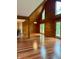 Open living room with high ceilings, wood paneling, hardwood floors, and natural light, perfect for entertaining at 1340 Apache Trl, Martinsville, IN 46151
