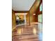 Open concept living room and kitchen with hardwood floors and wood-paneled walls, creating a warm and inviting space at 1340 Apache Trl, Martinsville, IN 46151