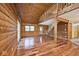 Spacious living room featuring wood paneled walls and gleaming wood floors at 1340 Apache Trl, Martinsville, IN 46151