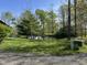 Scenic view of the property highlighting a tranquil pond reflecting the surrounding trees and greenery at 1340 Apache Trl, Martinsville, IN 46151